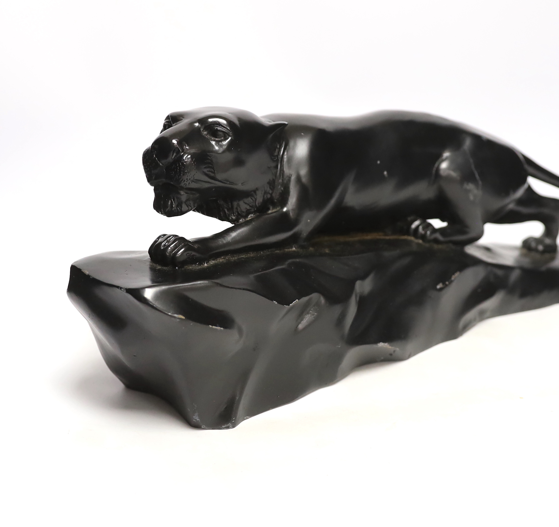 A bronzed black painted spelter panther, 50cm wide